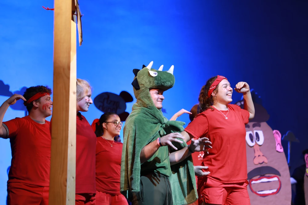 Young people dressed up in costumes dancing.